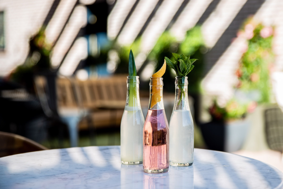 Fun summer drinks on a table in an outdoor patio environment.